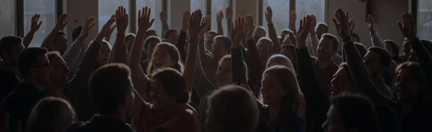 A congregation with hands raised in worship