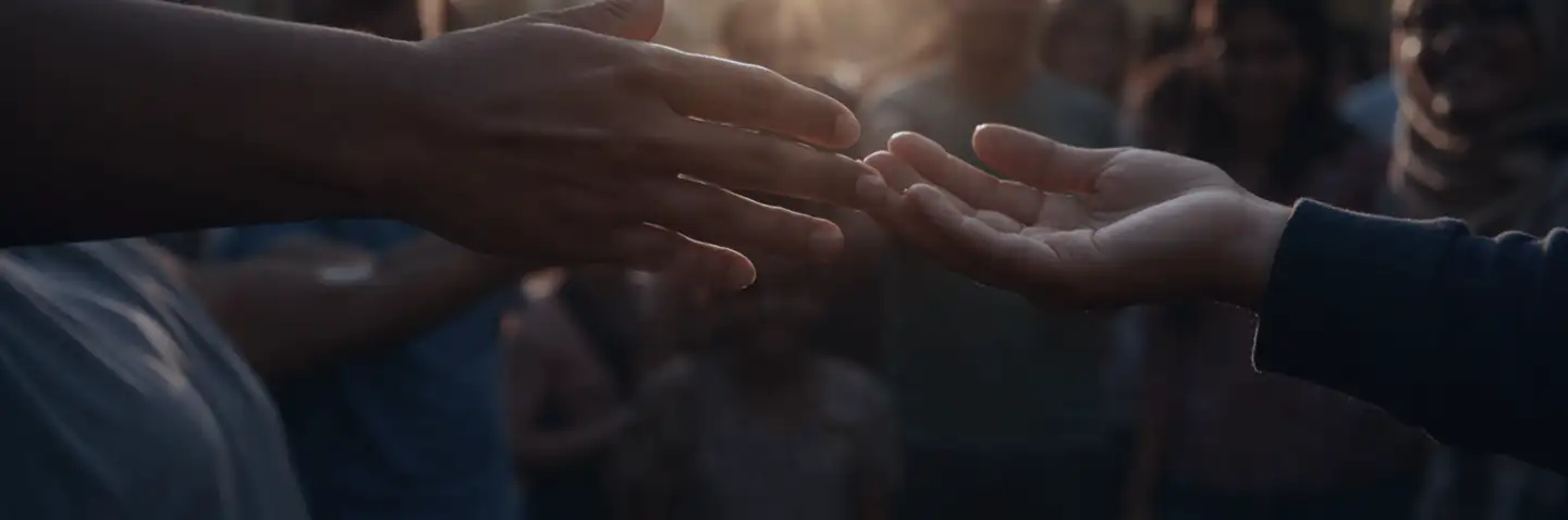 Two hands reaching toward each other